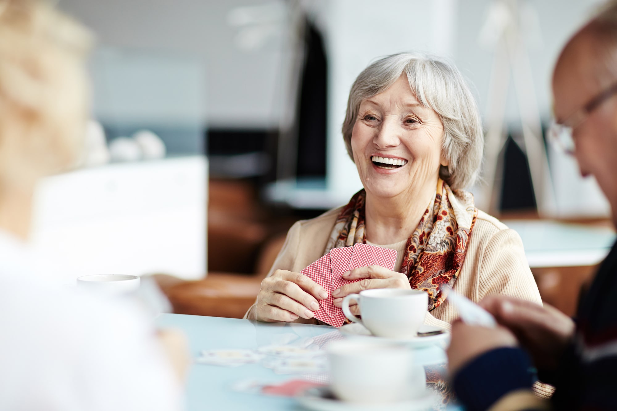 Happy_senior_woman_playing_cards